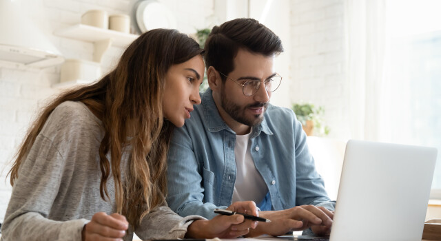 couple checking laptop