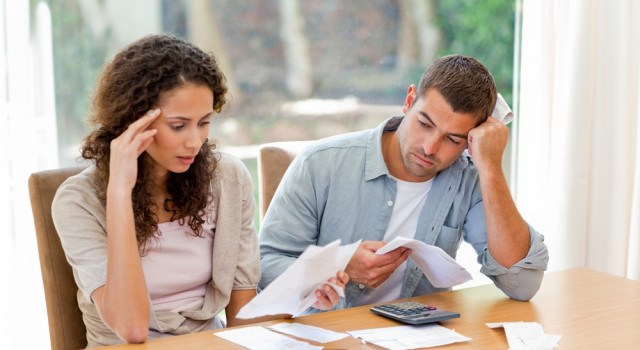 Young couple calculating their domestic bills at home